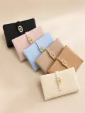 Portefeuille en cuir texturé avec fermoir nœud doré