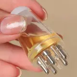 Applicateur de huile pour cheveux